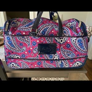 Vera Bradley rolling purple paisley duffel bag.